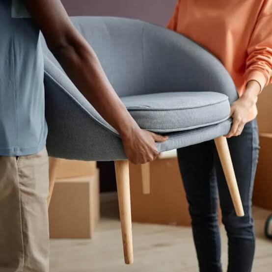 Image of movers moving a chair